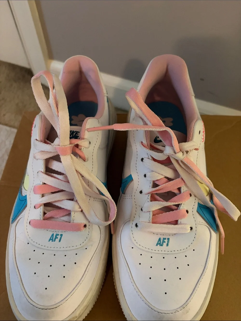 Nike Woman’s White Sneakers with Blue Swoosh and Pink Laces